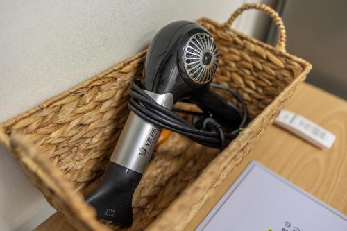 a hair dryer in a basket on a desk at Private Suncheon House in Suncheon