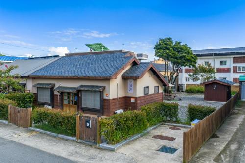 a house with a wooden fence in front of it at Private Suncheon House in Suncheon