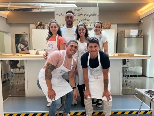 a group of people in a kitchen posing for a picture at Albergo Al Cacciatore Tortellinando in Valeggio sul Mincio