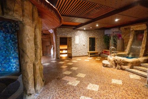 a room with a large room with a room with trees at Hotel Horizont in Baška Voda