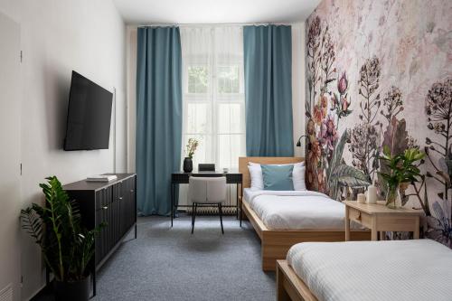 a hotel room with a bed and a desk in a room at Hotel Botanica by Goodnite cz in Brno