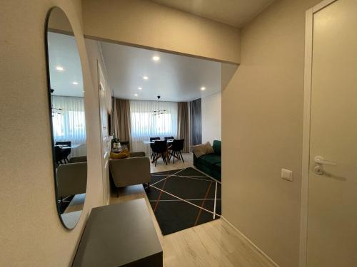 a room with a mirror and a living room at Like at home Daumani in Narva