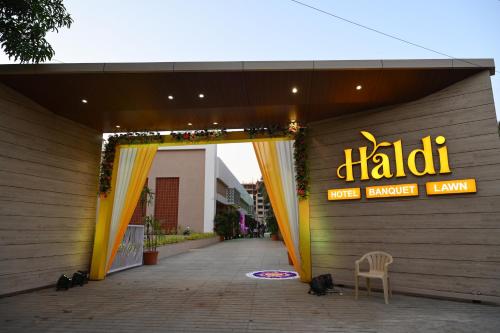 an entrance to a mall with a sign on a building at Hotel Haldi in Nashik