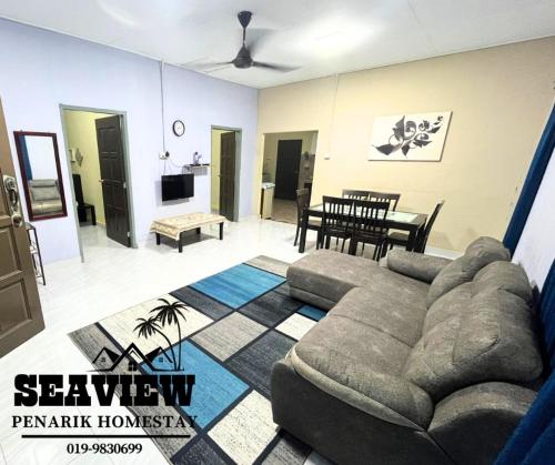 a living room with a couch and a table at SeaView Homestay in Kampong Ru Sepuloh