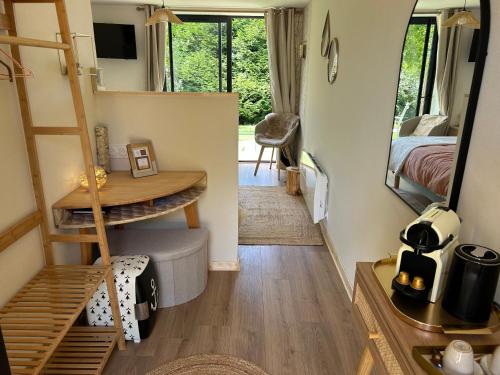 a tiny house with a staircase and a bedroom at Songe de Clarté in Plouigneau