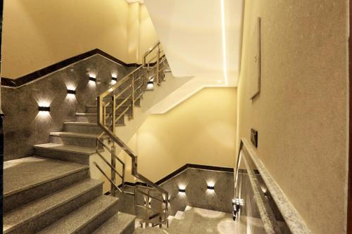 a staircase in a building with lights on it at Hotel Aroma Plaza Delhi Airport in New Delhi