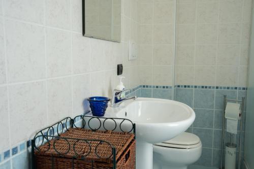 a bathroom with a sink and a toilet and a mirror at B&B Umbria Verde in Matigge