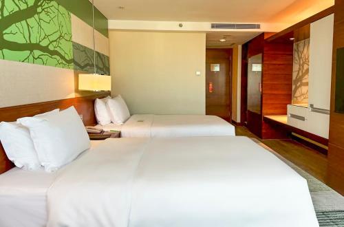 a hotel room with two beds in a room at Holiday Inn Shenzhen Donghua by IHG in Shenzhen
