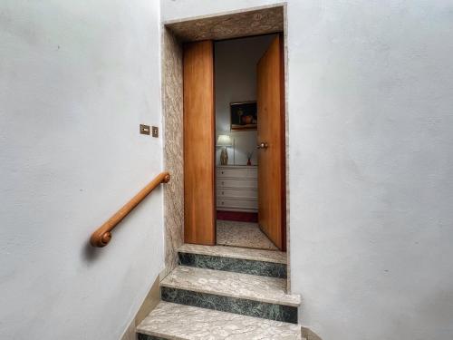 a staircase leading to a hallway with a door at Attico Altucci in Arezzo