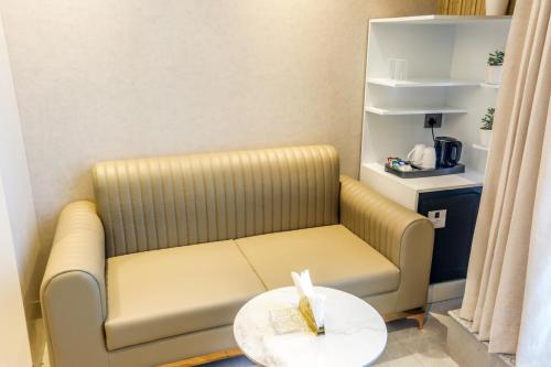a couch in a room with a coffee table at Hotel Aroma Plaza Delhi Airport in New Delhi