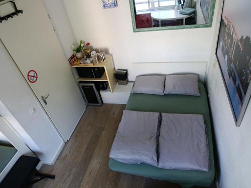 a small room with two beds and a desk at All you need, a comfy place in Amsterdam