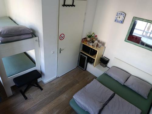 a small room with a bed and a couch at All you need, a comfy place in Amsterdam