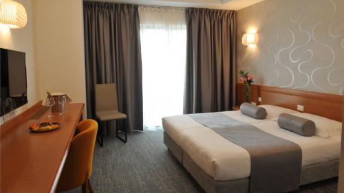 Una cama o camas en una habitación de Hotel Venko