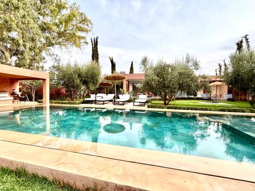 a swimming pool in the yard of a house at Villa Essalam Marrakech in Marrakech