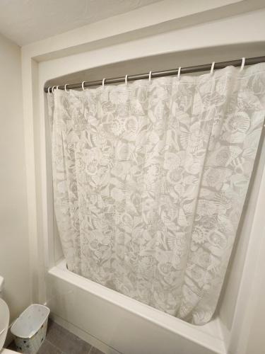a bathroom with a shower curtain in a bath tub at Peace Abode in Dieppe