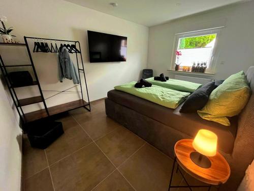 a living room with a couch and a window at Quartier 4 - modern und mit bester Verkehrsanbindung in Oberhausen