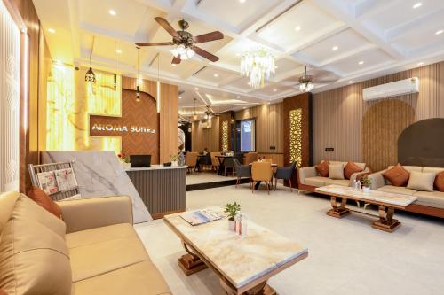 a lobby with couches and tables in a store at Hotel Aroma Plaza Delhi Airport in New Delhi