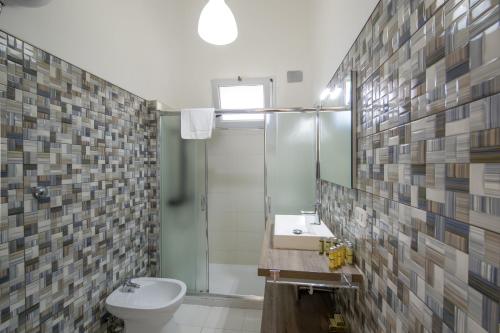 a bathroom with a shower and a toilet and a sink at Casa Punta Paradiso - Hot Tub and Panoramic Garden in Praiano