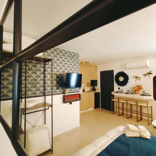 a loft apartment with a staircase and a kitchen at El Jardín de las Libélulas in Coria