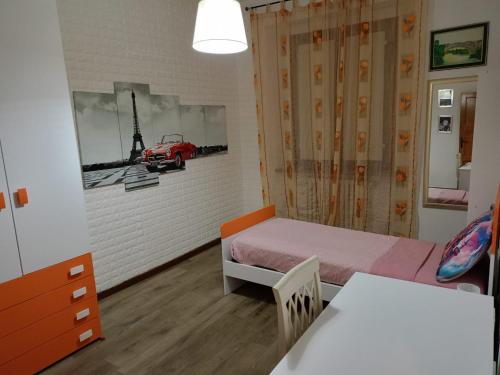 a small room with a bed and a car on the wall at Giulia House in Certaldo