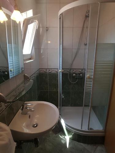 a bathroom with a shower and a sink at Apartments Andrijašević in Makarska