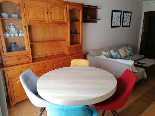 a room with a table and chairs and a couch at Apartamento para 6 personas en Barbastro in Barbastro
