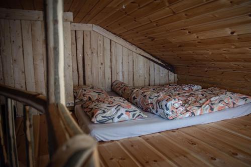 a room with two beds in a wooden cabin at Design Cabin with Jacuzzi, Sauna & Nature in Pertunmaa