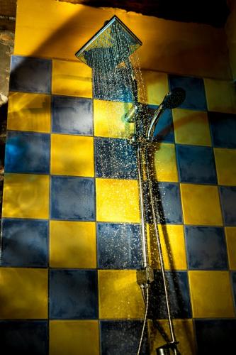 a shower with water on a checkered floor at Kleio in Elatochori