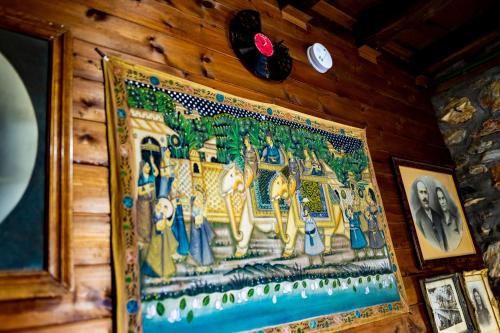 a tapestry hanging on a wooden wall at Kleio in Elatochori