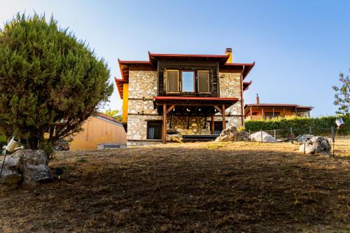 a house with a tree in front of it at Kleio in Elatochori