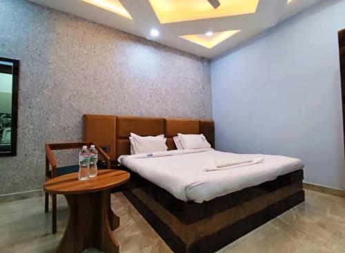 a bedroom with a bed and a table in it at The Vrinda Haritage Siwan in Siwān