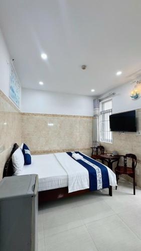 a bedroom with a bed and a television in it at Victory Hotel 153-155 in Ho Chi Minh City