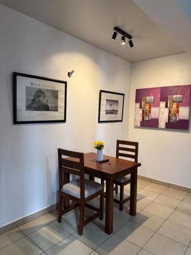 a dining room with a table and two chairs at Pumzika Town House in Arusha