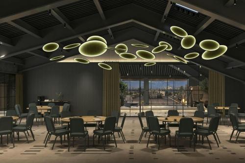 a dining room with tables and chairs and a chandelier at The Westin Istanbul Nisantasi in Istanbul