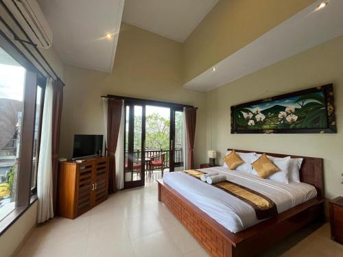a bedroom with a large bed and a balcony at Natha Ubud Private Pool Villa by EPS in Ubud