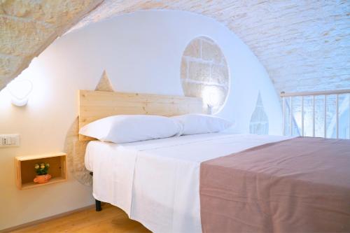 Postel nebo postele na pokoji v ubytování Il Nido in Pietra - Il Tuo RIFUGIO ad OSTUNI