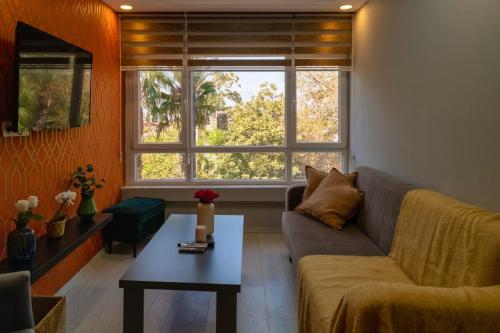 a living room with a couch and a table at Bright Yellow Flat Near Beach Old Town Free Wifi in Antalya