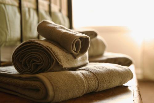 a pile of towels sitting on top of a table at Boutique Apartment - Sleeps 6 & Free Parking in Ilkley