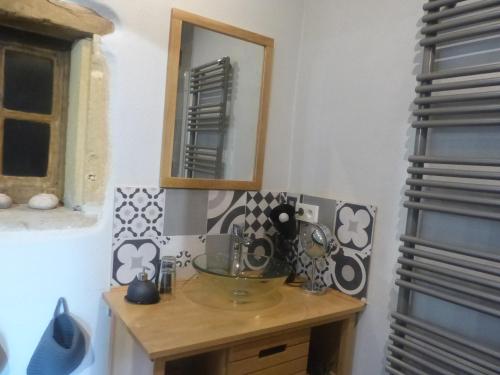 a bathroom with a wooden table with a mirror at la Bergerie du Bois Joannin 1497 route des fleuriats in Iguerande