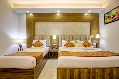 a hotel room with two beds in a room at Hotel The Prithvi Near Delhi Airport in New Delhi