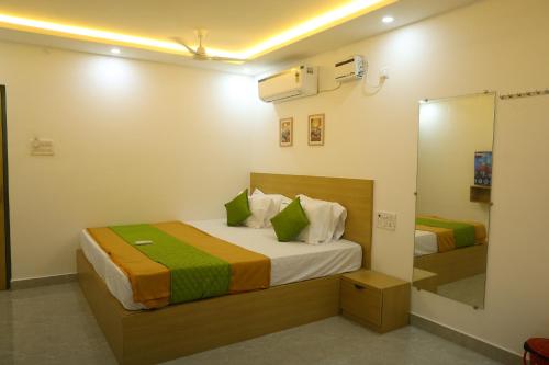 a bedroom with two beds and a mirror at Aeroview Homestay Near Chennai Airport and Rela Hospital in Chennai