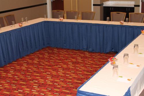 a long table with white tables with flowers on it at Courtyard by Marriott Vicksburg in Vicksburg