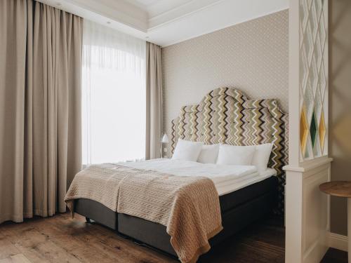 Postel nebo postele na pokoji v ubytování Lydia Hotel