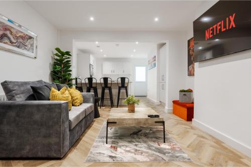a living room with a couch and a table at Riverside Work-Stay Free Dedicated Parking in Warrington