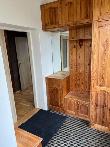 an empty room with wooden cabinets and a hallway at Prázdninový dům Šternberk in Šternberk
