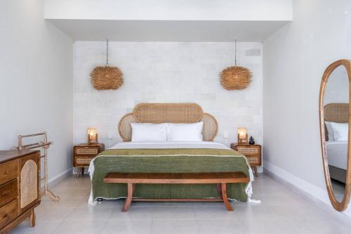 a bedroom with a bed and a mirror at Villa Waterlily A Sanur in Sanur