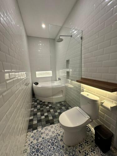 a bathroom with a toilet and a bath tub at Matra Apartment in Canggu
