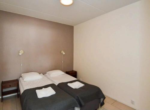 a bedroom with two beds and two lamps at Levistar II 1414 in Kittilä