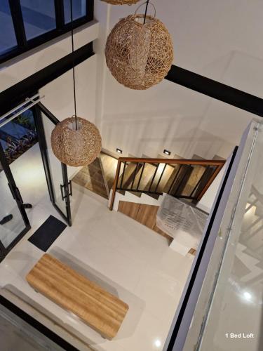 a room with two chandeliers and a table at Matra Apartment in Canggu