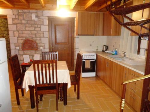a kitchen with a table and chairs and a stove at Menina Farm Kalamata Countryside in Perivolákia